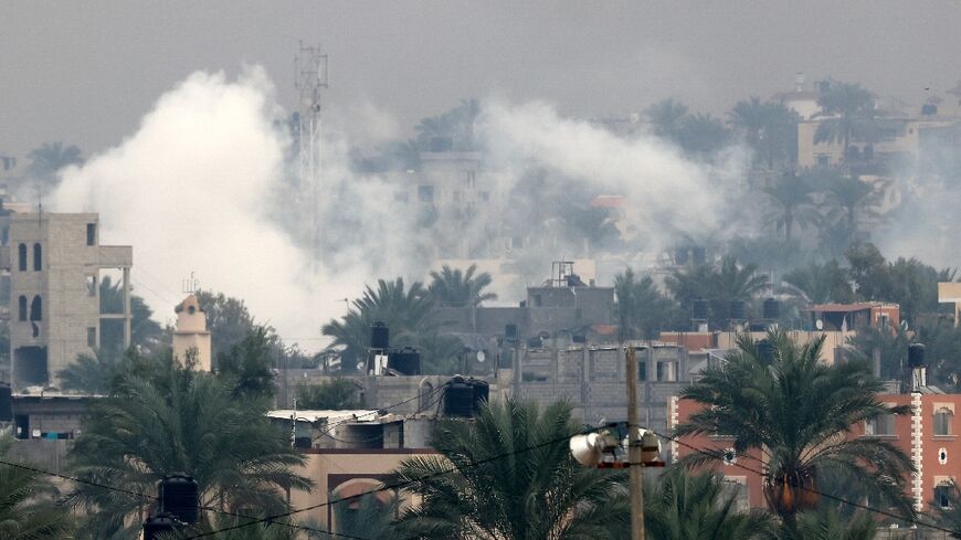 Smoke rises above Khan Yunis in the southern Gaza Strip as battles rage between Israel and Hamas militants on December 5, 2023