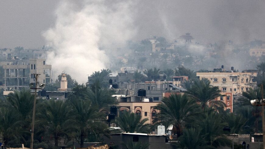 Smoke rises above Khan Yunis in southern Gaza as Israeli troops engage in ground combat in the city