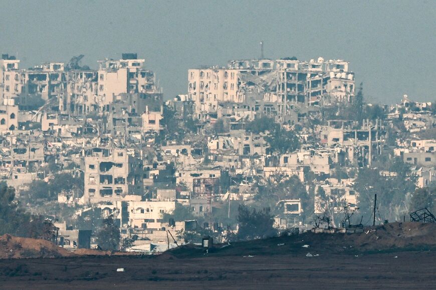 A picture taken from southern Israel shows destroyed  buildings in Gaza 