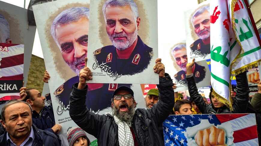 TOPSHOT - Protesters hold pictures of Iranian commander Qasem Soleimani, during a demonstration outside the US consulate in Istanbul, on January 5, 2020, two days after top Iranian commander Qasem Soleimani was killed by a US drone strike. - A US drone strike killed top Iranian commander Qasem Soleimani at Baghdad's international airport on January 3, dramatically heightening regional tensions and prompting arch enemy Tehran to vow "revenge". (Photo by Yasin AKGUL / AFP) (Photo by YASIN AKGUL/AFP via Getty 