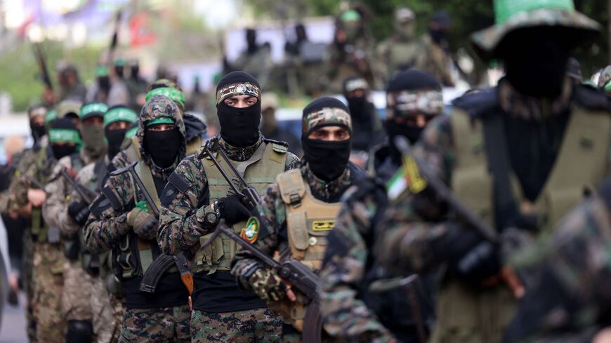 Members of Al-Qassam Brigades, the armed wing of the Palestinian Hamas movement, march in Gaza City on May 22, 2021, in commemoration of senior Hamas commander Bassem Issa who was killed along with other militants in Israeli airstrikes last week.
