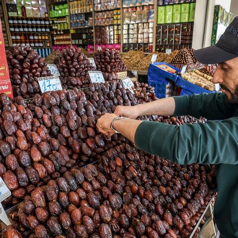 In this picture taken on April 2, 2023, a vendor arranges dates at his shop in Rabat, during the Muslim holy fasting month of Ramadan. (Photo by FADEL SENNA / AFP) (Photo by FADEL SENNA/AFP via Getty Images)