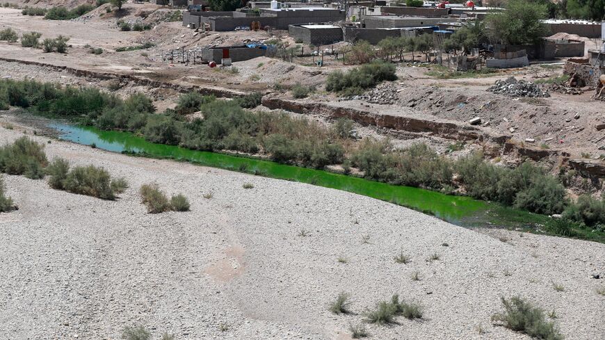 A picture shows a view of the dried-up bed of the al-Kalal River in the city of Badrah, near the Iran border, on August 28, 2023. Iraq's drought reflects a decline in the level of waterways due to the lack of rain and lower flows from upstream neighboring countries Iran and Turkey.