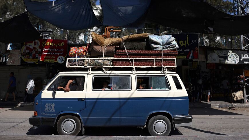 A Palestinian van carrying a family and their belongings arrives at the Rafah refugee camp, in the southern Gaza Strip on Oct. 15, 2023. 