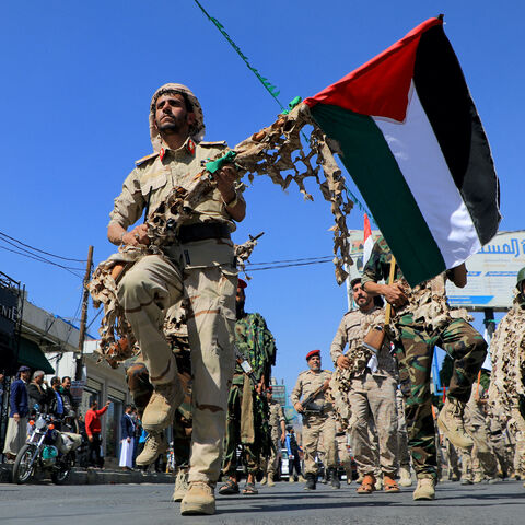 Forces loyal to Yemen's Huthi rebels hold up Palestinian flags as they march in a show of solidarity with the Palestinians on October 15, 2023, in Sanaa. (Photo by MOHAMMED HUWAIS/AFP via Getty Images)