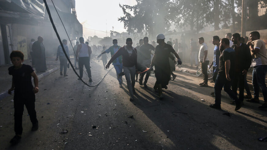 People carry an injured person after Israeli air raids in the southern Gaza Strip on Nov. 7, 2023 in Khan Yunis, Gaza.